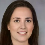 A portrait of a woman with long brown hair.